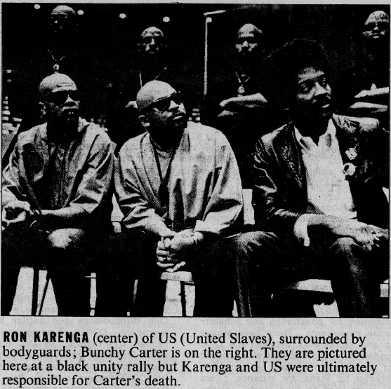 (Ron Karenga (center) of US (United Slaves), surrounded by 
				bodyguards; Bunchy Carter is on the right. They are pictured here at a 
				black unity rally but Karenga and US were ultimately responsible for 
				Carter's death.)